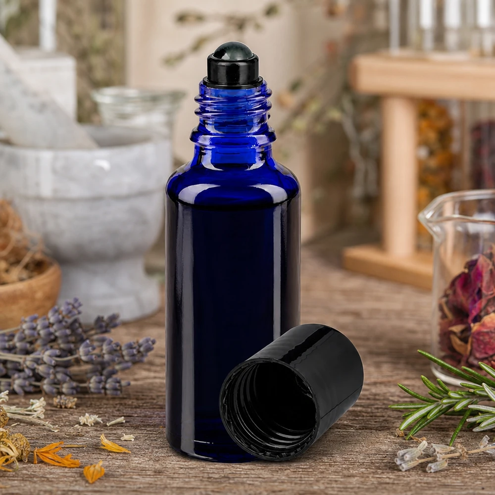 Flacone ApoGlas da 30 ml blu cobalto con applicatore roll-on nero tra erbe essiccate